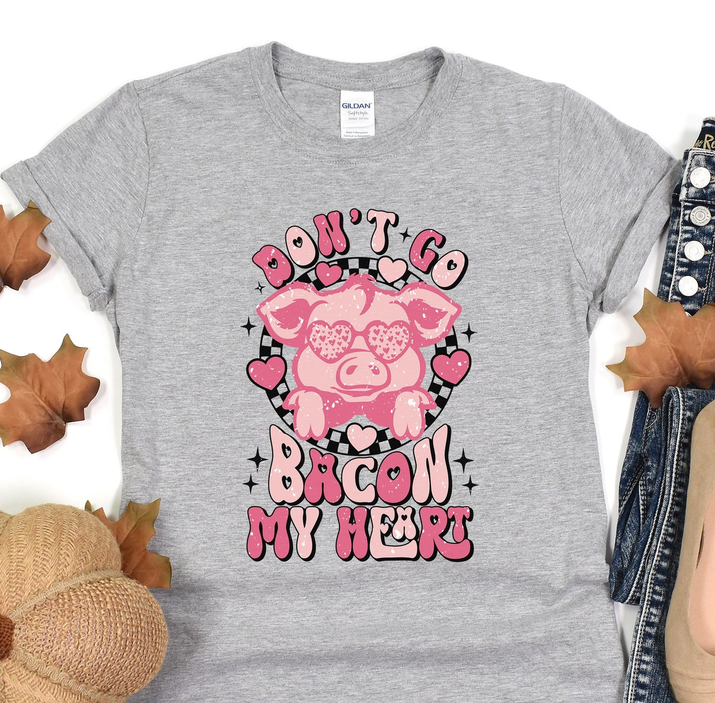 a gray shirt with a pink pig on it