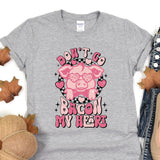 a gray shirt with a pink pig on it