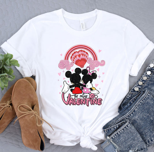 a white shirt with mickey and minnie mouse on it