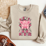 a sweater with a pig on it next to a pair of shoes