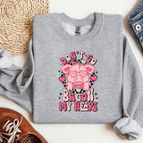 a gray sweatshirt with a pink pig on it