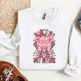 a white shirt with a pink pig on it
