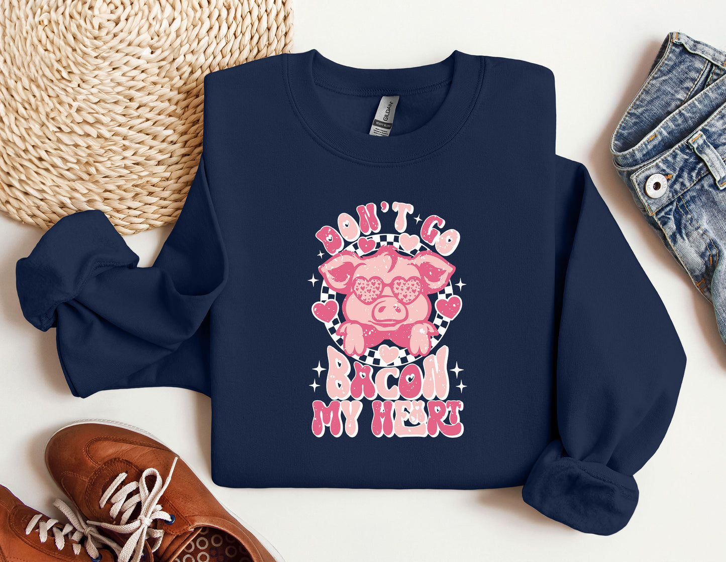 a blue sweatshirt with a pink pig on it