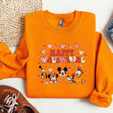 a pair of sneakers and a sweater with mickey mouse on it