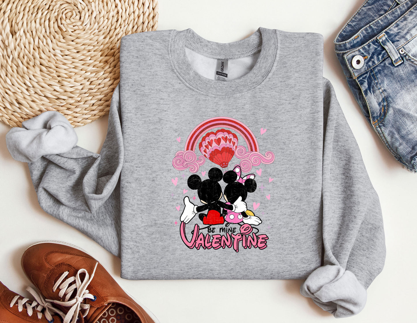 a sweater with a mickey and minnie mouse on it