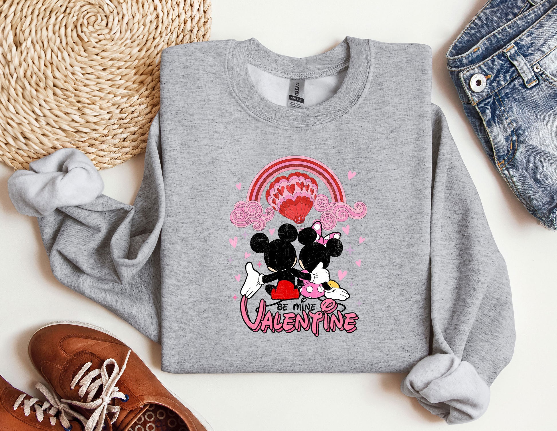a sweater with a mickey and minnie mouse on it