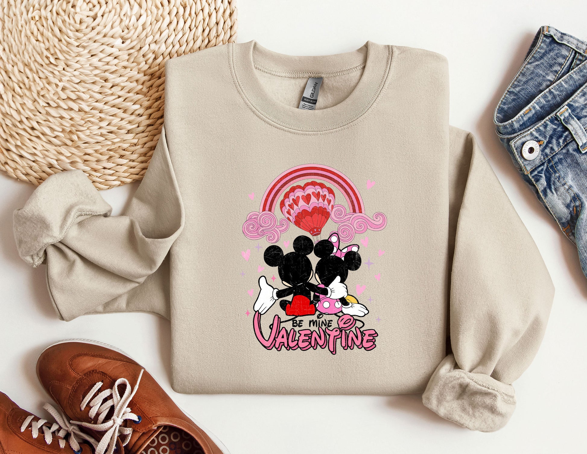 a pair of shoes and a sweater with a mickey mouse on it