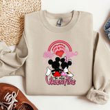 a pair of shoes and a sweater with a mickey mouse on it