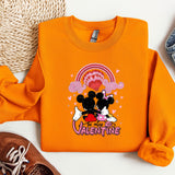 a pair of shoes and an orange shirt with a mickey mouse on it