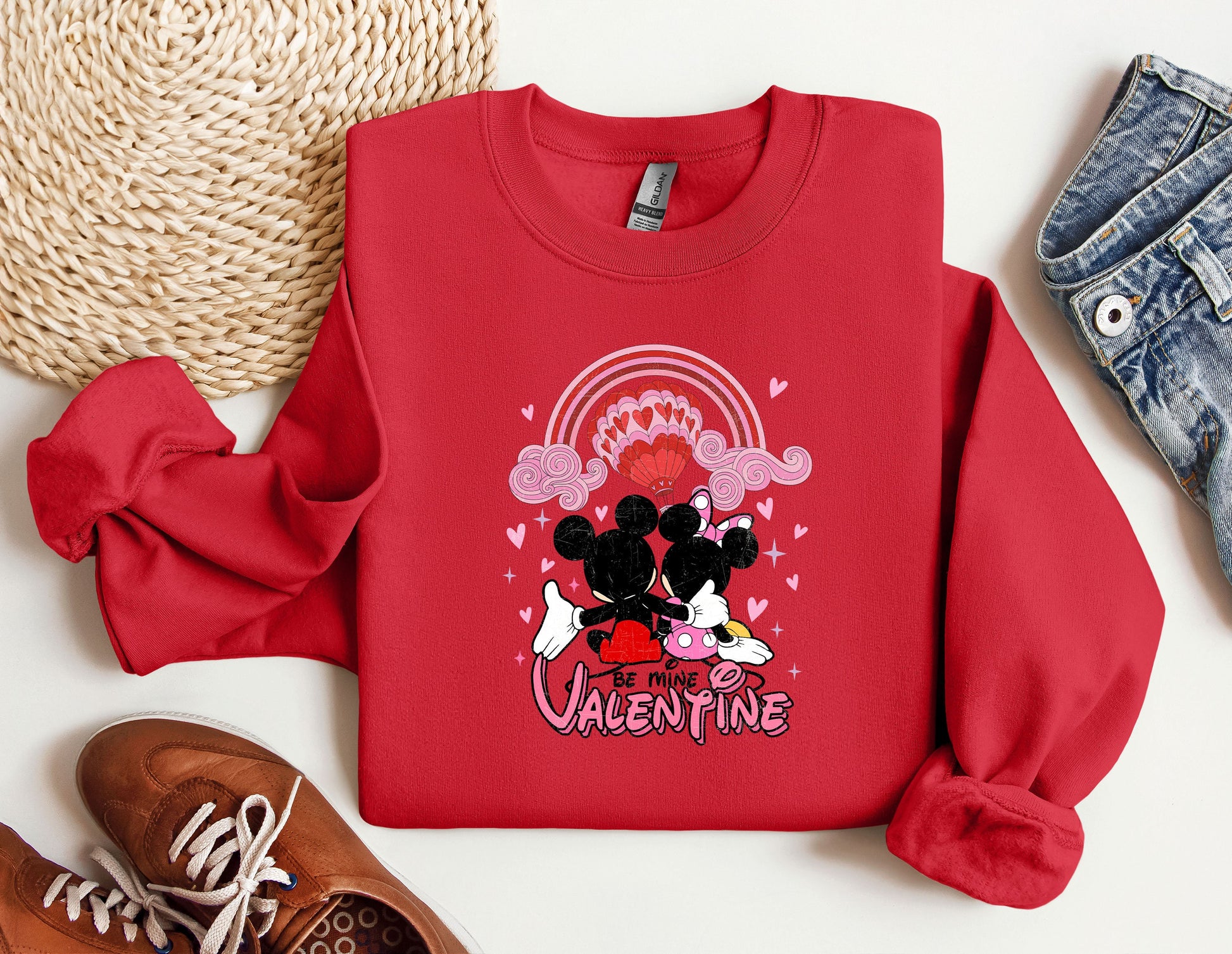 a red sweatshirt with a mickey mouse graphic on it