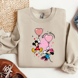 a sweater with a mickey mouse and minnie mouse on it
