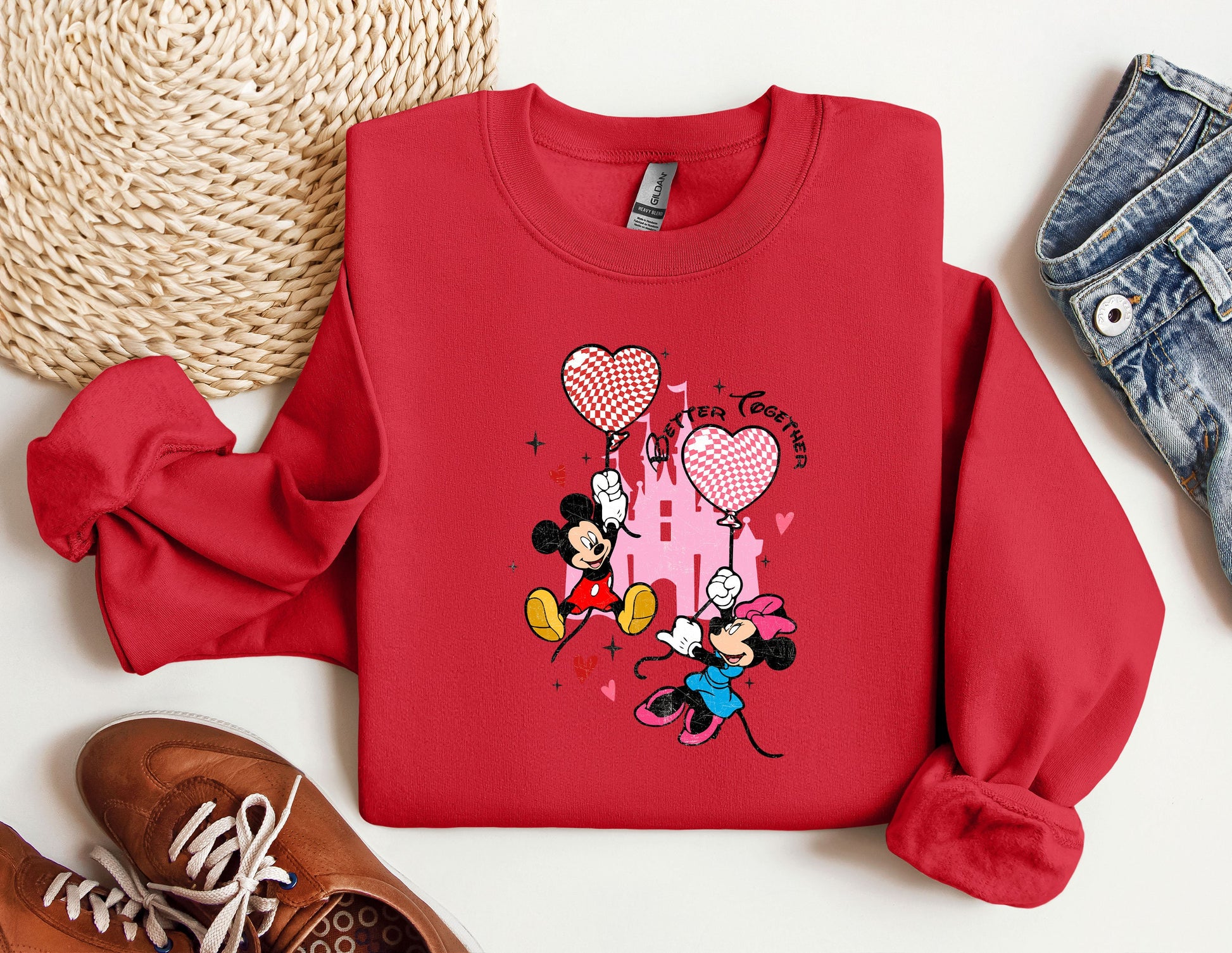 a red sweatshirt with mickey mouse on it