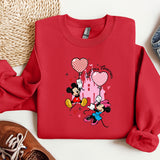a red sweatshirt with mickey mouse on it