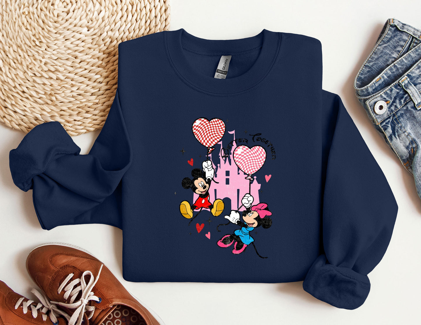 a blue sweatshirt with mickey mouse and minnie mouse on it