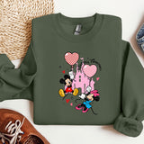 a green sweatshirt with mickey mouse and minnie mouse on it
