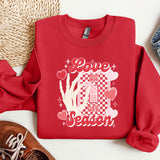 a red sweatshirt with a picture of a woman's hand and hearts on it