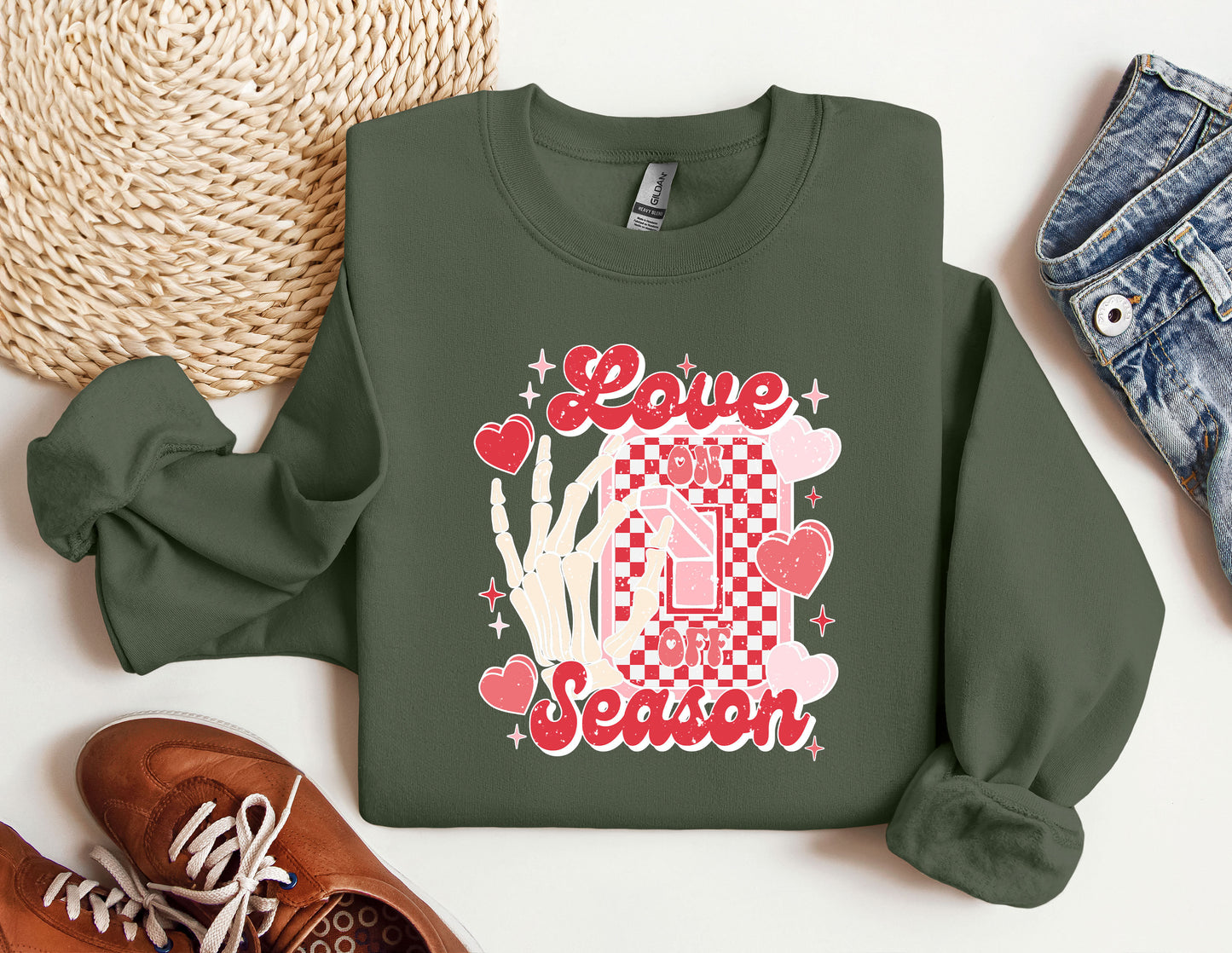 a green sweatshirt with a picture of a house and hearts on it