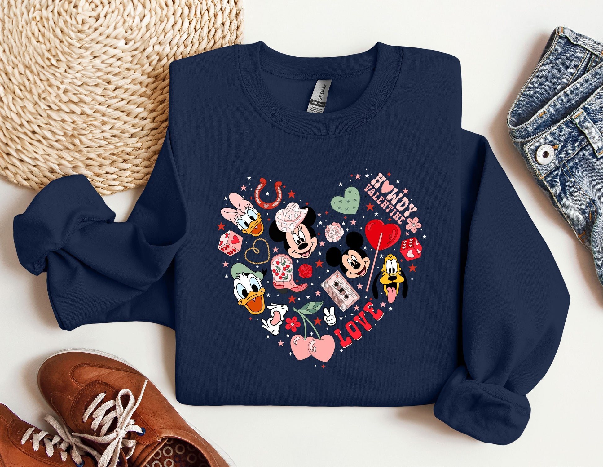 a mickey mouse heart shaped sweatshirt next to a pair of sneakers