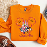 a pair of shoes and an orange shirt with mickey mouse on it