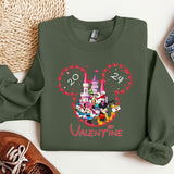 a green sweatshirt with mickey mouse and friends on it