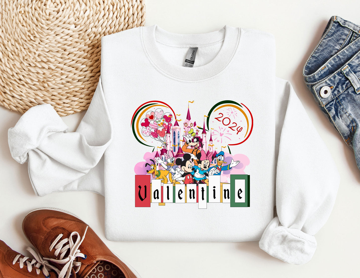 a mickey mouse sweatshirt with a pair of shoes next to it