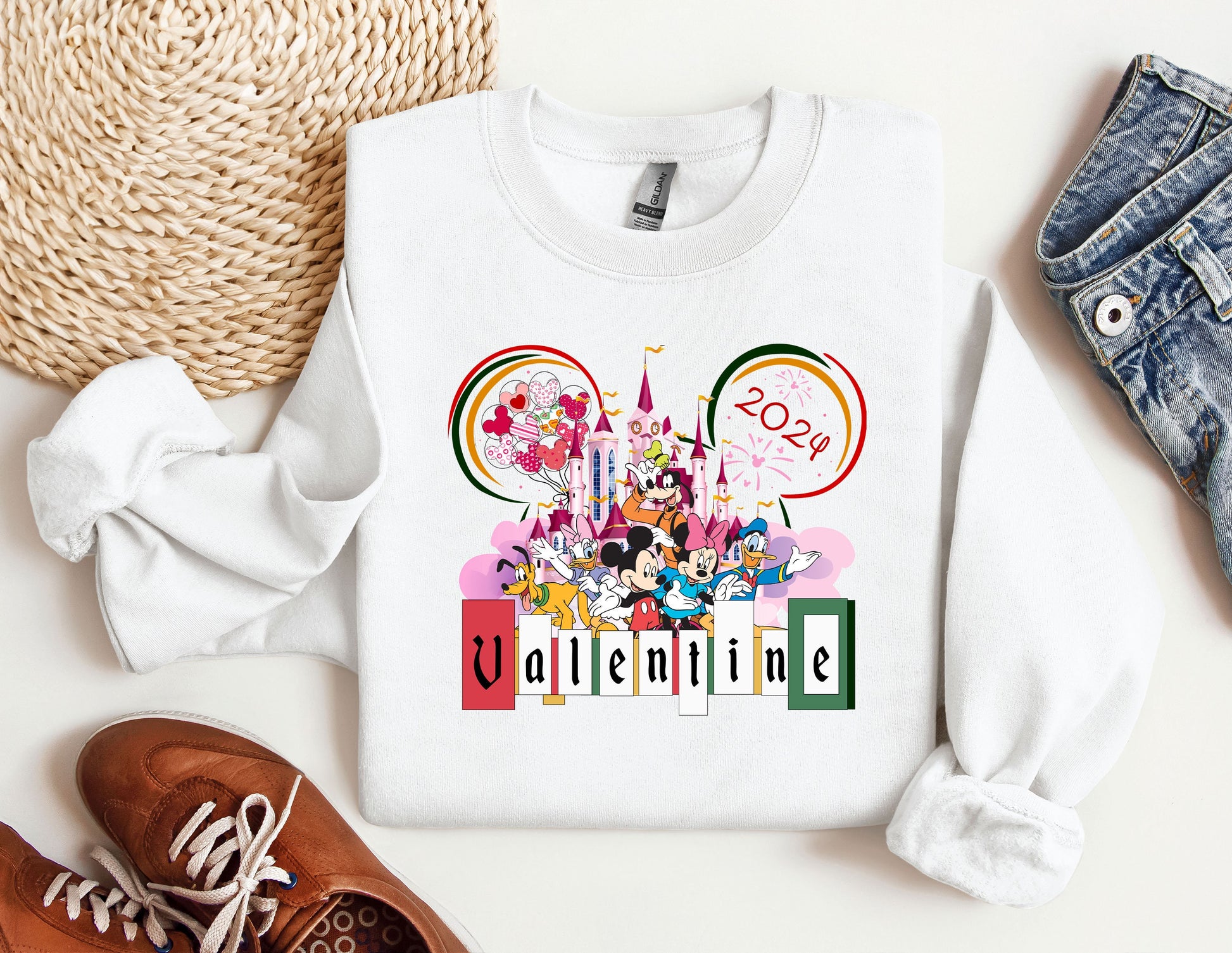 a mickey mouse sweatshirt with a pair of shoes next to it