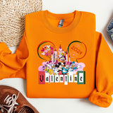an orange shirt with mickey mouse on it next to a pair of shoes