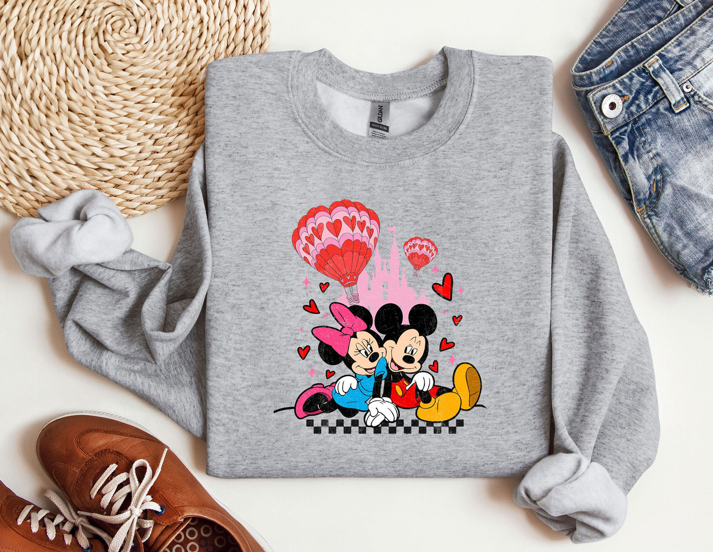 a sweatshirt with a mickey and minnie mouse on it