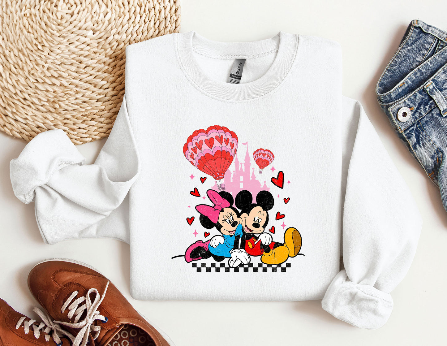 a mickey and minnie mouse shirt next to a pair of shoes