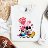 a mickey and minnie mouse shirt next to a pair of shoes