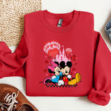 a red sweatshirt with mickey and minnie mouse on it