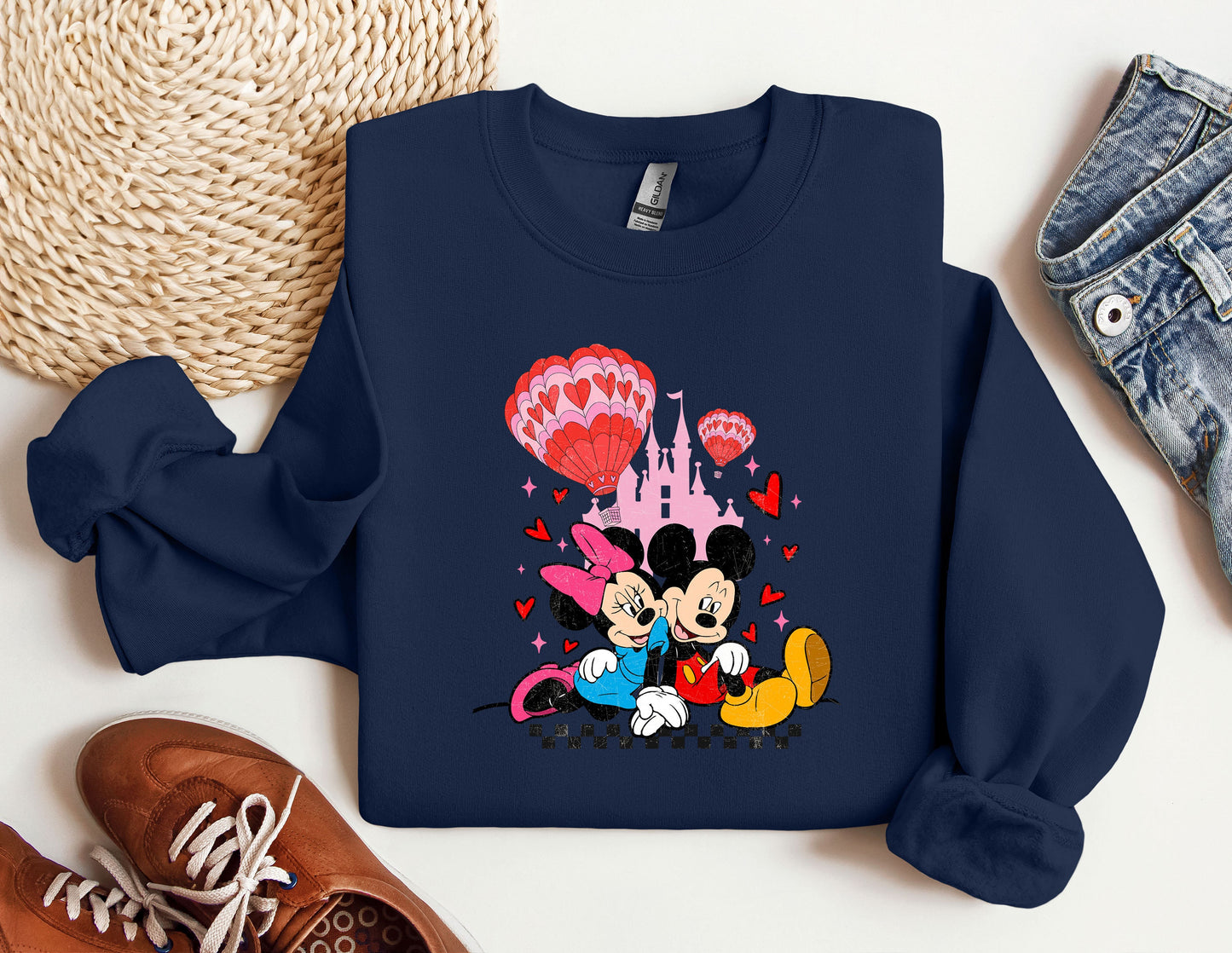 a mickey mouse and minnie mouse shirt next to a pair of sneakers