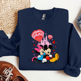 a mickey mouse and minnie mouse shirt next to a pair of sneakers