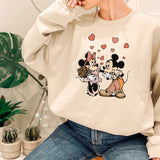 a woman wearing a mickey and minnie mouse sweatshirt