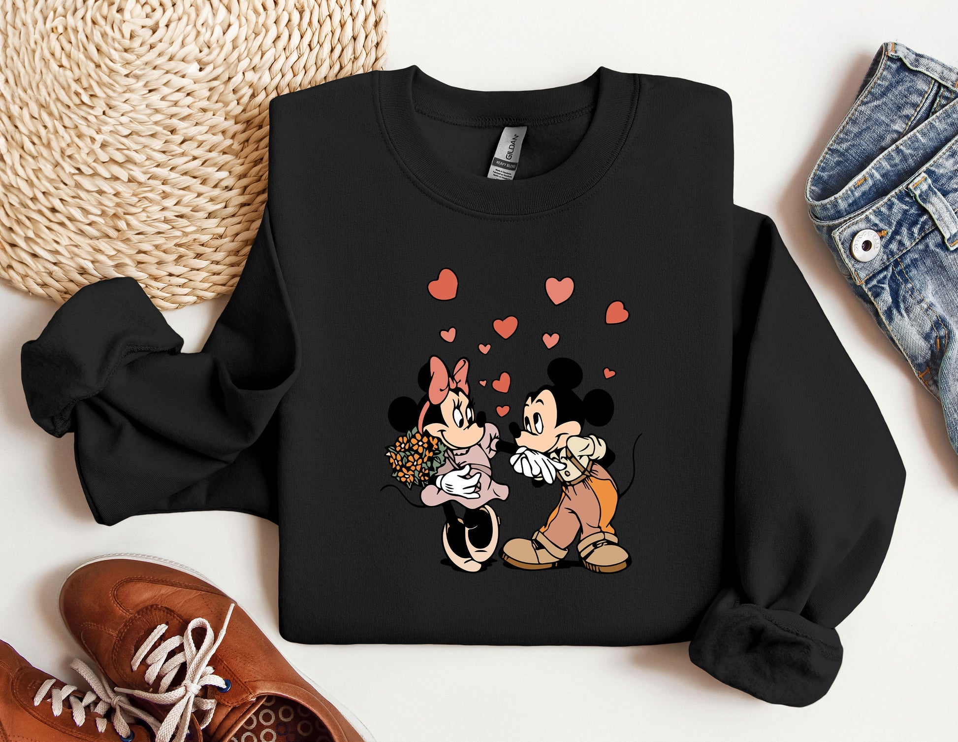 a couple of mickey and minnie mouses on a black shirt