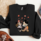a couple of mickey and minnie mouses on a black shirt