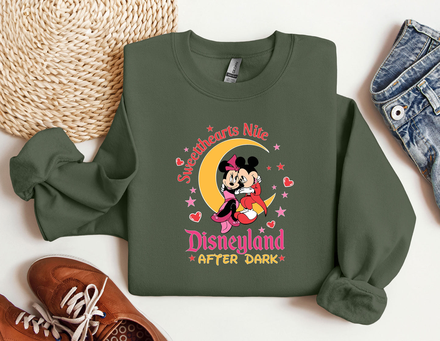 a green sweatshirt with a mickey mouse on it