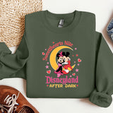 a green sweatshirt with a mickey mouse on it