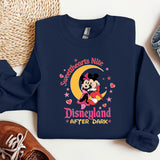 a sweatshirt with a mickey mouse on it next to a pair of sneakers