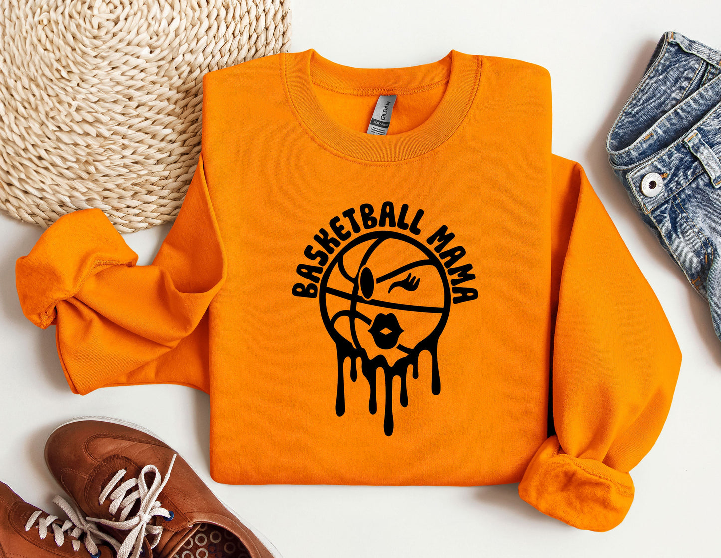 an orange sweatshirt with a basketball drawn on it