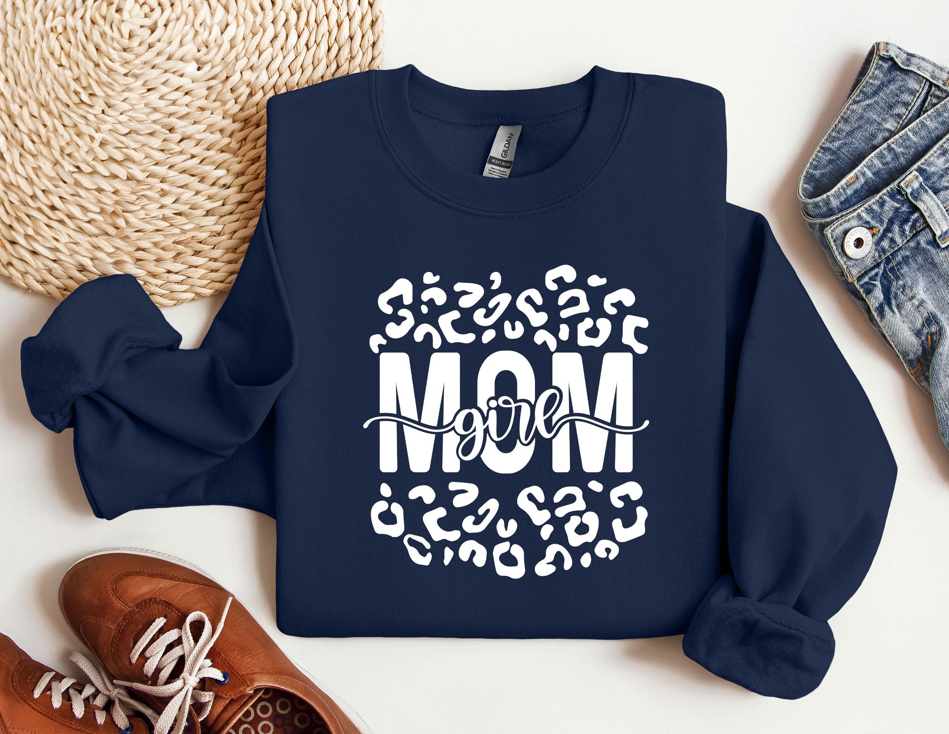 a sweatshirt with the words mom on it next to a pair of shoes