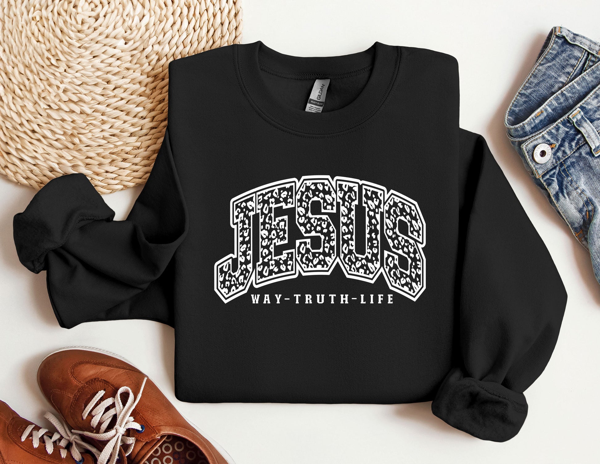 a black sweatshirt with the word jesus on it