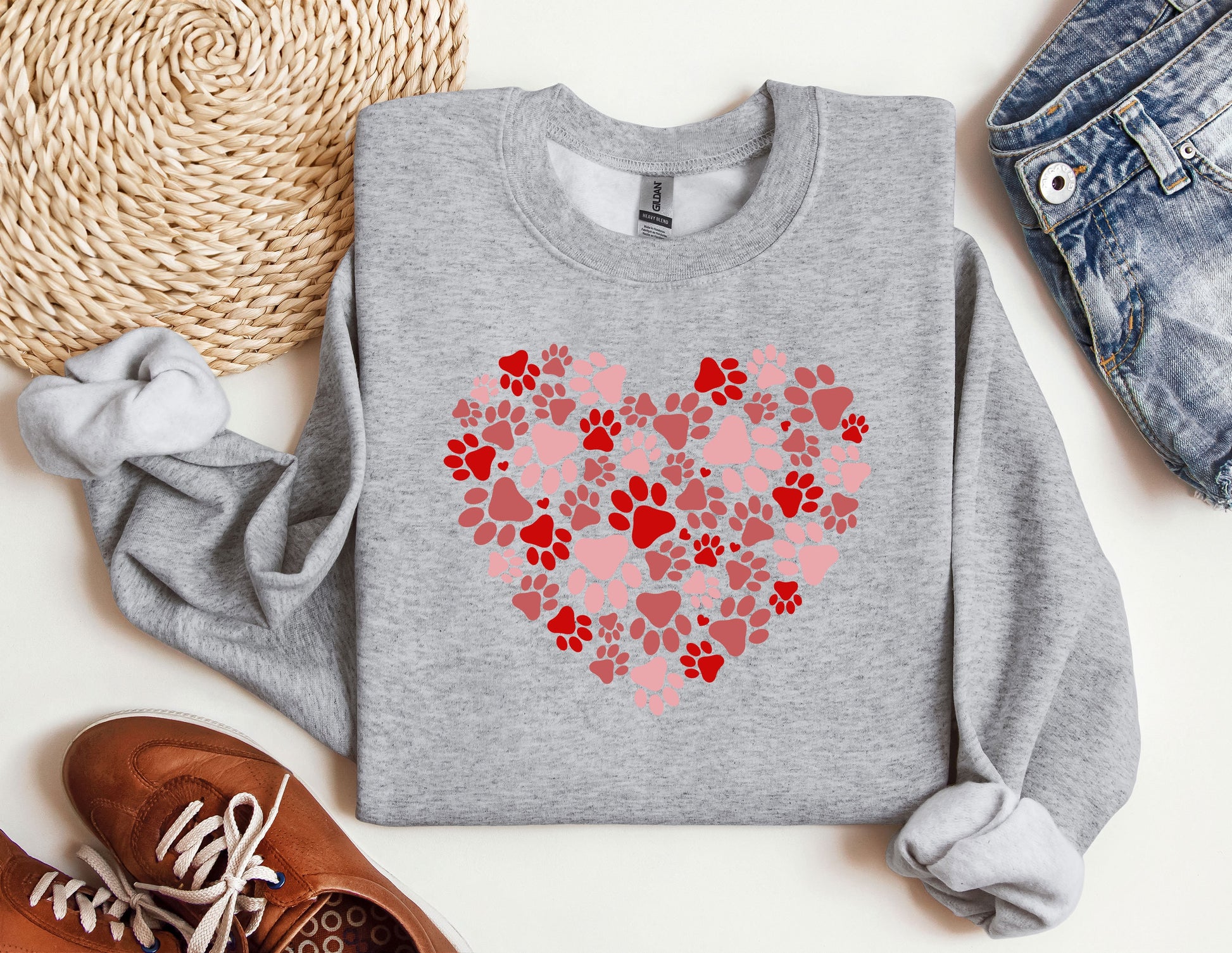 a sweater with a heart made out of paw prints