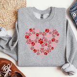 a sweater with a heart made out of paw prints