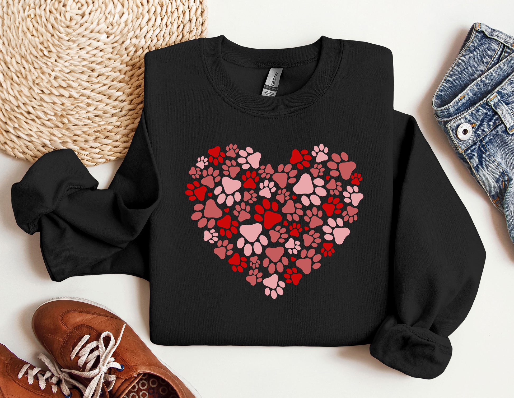 a heart made of paw prints on a black sweatshirt