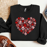 a heart made of paw prints on a black sweatshirt