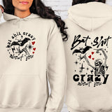 a woman wearing a white hoodie with a skeleton on it