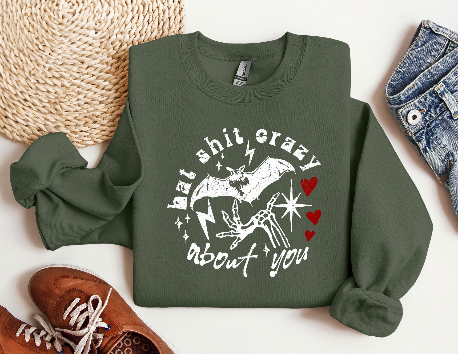 a green sweatshirt with a picture of a bat on it