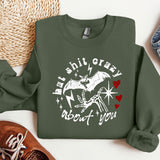 a green sweatshirt with a picture of a bat on it