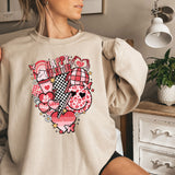 a woman is sitting on a bed wearing a sweatshirt